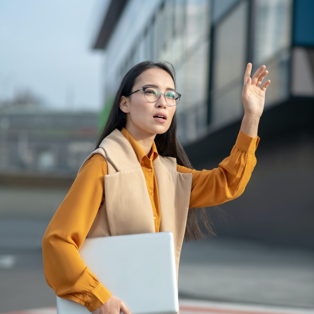 young-asian-pretty-woman-waving-her-hand-on-the-road.jpg
